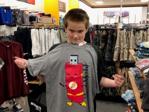 CC OSB 635x478 Boy showing off his new shirt at Operation School Bell event.