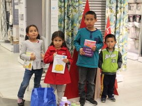 Kids w Books Cute kids at Operation School Bell shopping event showing off their books and clothing