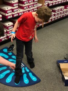 Sizing Foot Boy having his foot sized at an Operation School Bell event