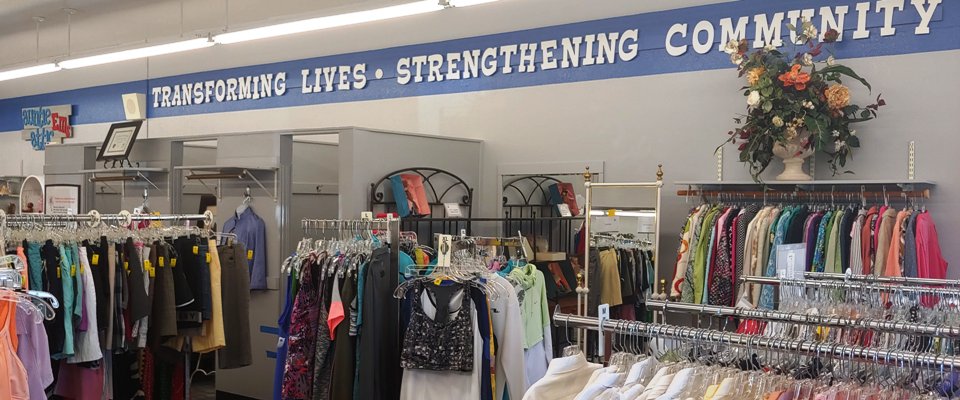 Thrift Shop 960x400 Inside of thrift shop with racks of clothing and dressing rooms