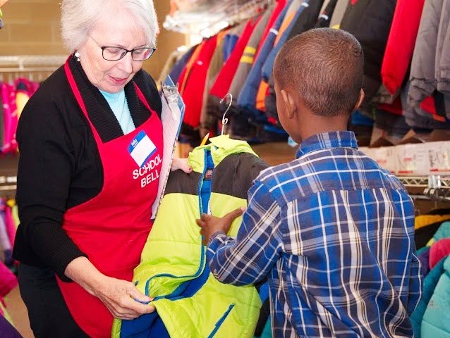 child picking jacket 638x480 Member showing jacket to child