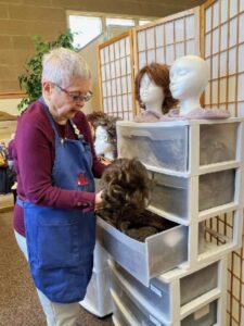 Volunteer Sorting Wigs Member sorting wigs
