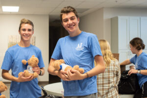 Assisteen guys holding Aldo Bears