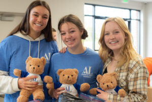 Assisteen three girls holding Aldo bears