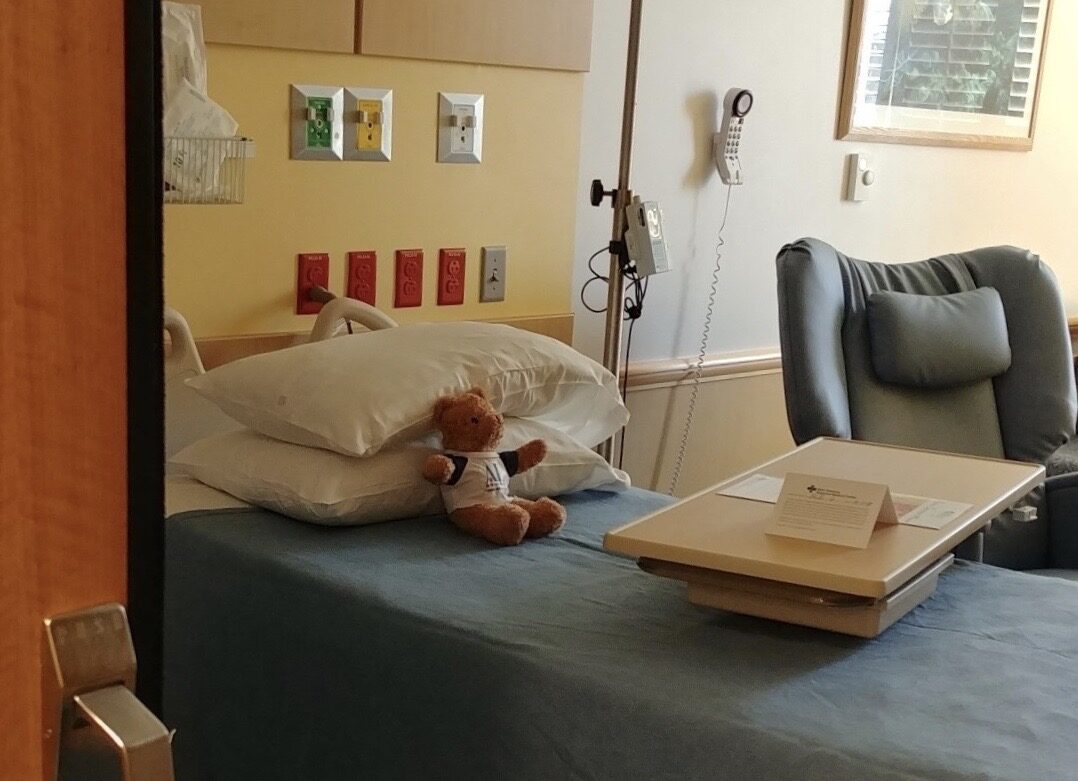 Teddy bear on bed peds. A