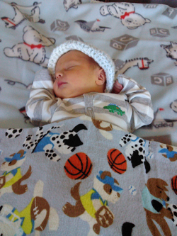 Baby in layette from Caring Hands