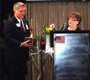 James Salas receiving the Operation School Bell Award from Immediate Past President Mary Elledge.