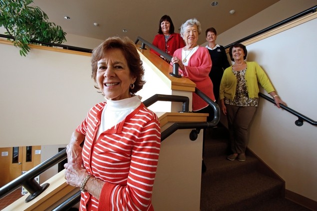 Phyllis Busch and (on stairs, from left) Donna Day, Roberta Swanson, Mary Elaine Burgess and Neena Blackwell volunteer with the Assistance League of Everett . Busch leads the league’s graduations awards. Volunteers work to identify high school students who are in need of help to celebrate their senior years. Students are given awards to pay for things like yearbooks, senior prom or Advanced Placement tests.