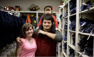 Justin LeMoine, his wife, Lora, and his daughter, Kayleanne, deliver donations Thursday at the Assistance League of Tulsa, where Justin received clothes as a foster child. MIKE SIMONS/Tulsa World