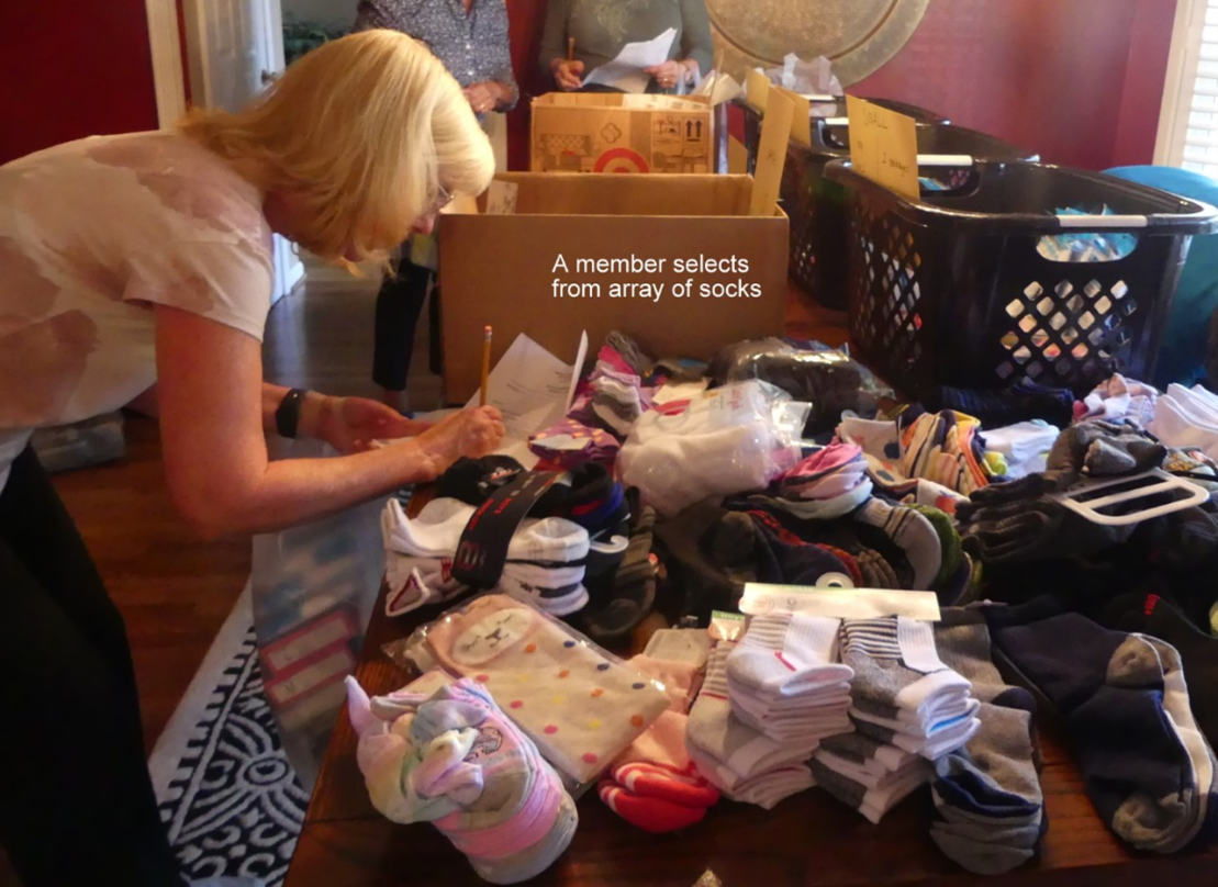 Northern Virginia - Assistance League assembles clothing bundles for schools (002) A picture containing text, person, indoor, cluttered